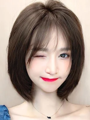 Sweet lolita short bob wig deep brown front view with wispy air bangs on model wearing blue off-shoulder top