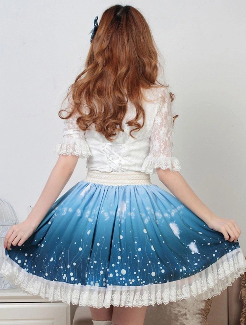 Back view of deep blue ombre sweet lolita SK skirt with ruffled white lace hem and gradient print design showing silhouette