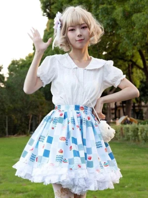Sweet lolita SK skirt light sky blue floral print front three-quarter view with white ruffled hem and doll collar blouse outdoor park setting
