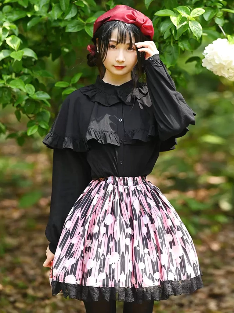 Sweet lolita SK skirt full front view with black ruffled blouse and pink black floral print lace hem outdoor garden setting