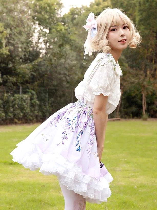 Three-quarter side back view flared lilac lolita skirt showing ruffled hem trim and graceful movement of fabric outdoor model photography