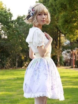 Sweet Lolita skirt with wisteria butterfly floral print worn outdoors with white ruffled blouse front three-quarter view showing lavender base color