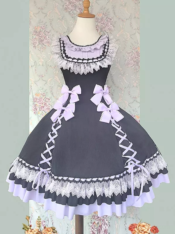 Sleeveless sweet lolita jumper dress in lilac purple with delicate lace collar, side lace-up details, and multi-layer ruffled hem displayed on dress form