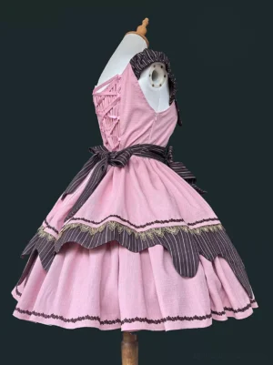Back view of pink sleeveless lolita jumper dress showing backless design, waist bow sash, and layered pleated ruffles