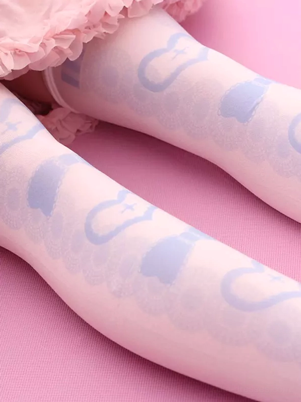 Close-up side view of sweet lolita stockings on leg, displaying soft printed heart and bow motifs in light blue, demonstrating authentic over-the-knee length and comfort fit