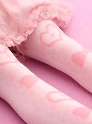 Soft textured pink velvet lolita knee-high socks side close-up view on model wearing ruffled skirt showing detailed heart and bow print design comfort fit
