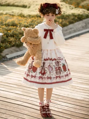 Sweet lolita strawberry teddy bear jumper dress full body front view outdoor walkway cream burgundy bow ruffled hem
