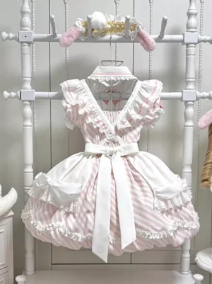 Pink and white vertical striped Sweet Lolita apron dress with ruffled trim cross v-neckline and white waist sash full front view