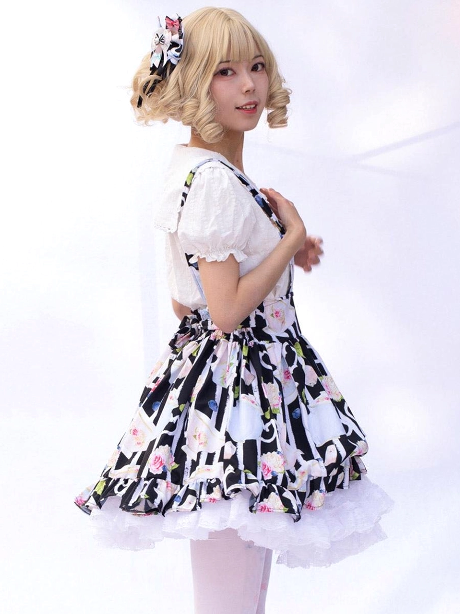 Lolita suspender skirt front view showing fitted waist and flared skirt silhouette with teacup print, studio background