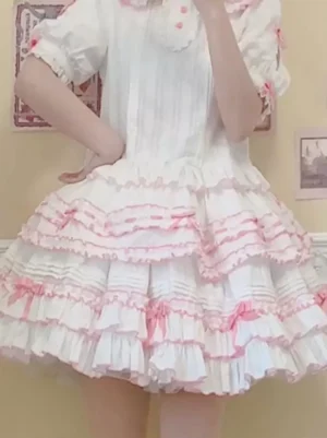Sweet Lolita tiered ruffle skirt with pink bows and ruffled trims on light sky blue base worn in half-body perspective shot