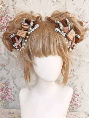 Sweet lolita twin bow hair headdress close-up front view showing detailed pearl trimmed bows and miniature dessert pendants on mannequin