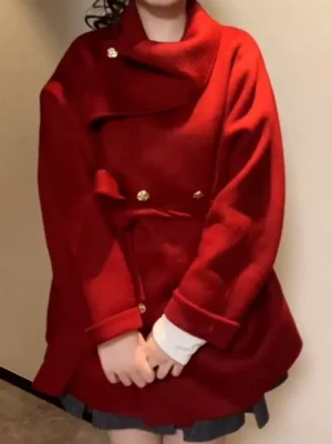 Sweet lolita burgundy wool overcoat with asymmetrical stand collar and gold button details worn over white lace inner wear, front medium shot view