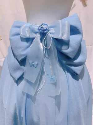 Close-up detailed view of lolita waist bow accessory featuring rose flower center pearl tassels and butterfly charms on sheer ribbons