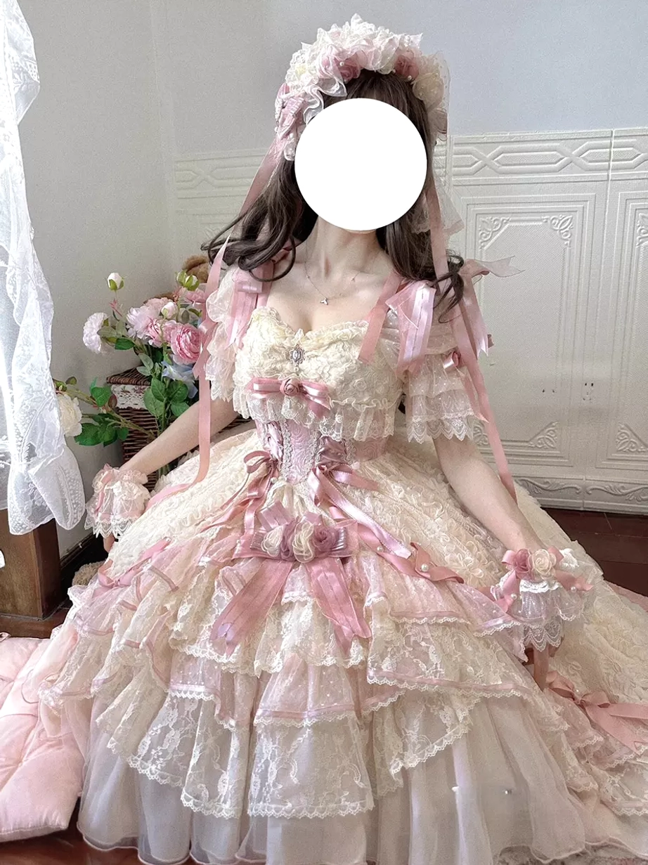 Seated side view of sweet lolita wedding dress displaying elegant train ethereal skirt layering and bridal veil with flower headdress