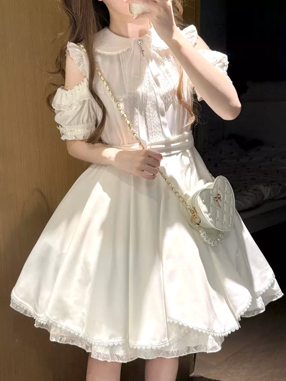 Sweet lolita white mini dress front three-quarter view on model with peter pan collar cold-shoulder puff sleeves and coordinating heart-shaped crossbody bag styling