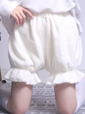 Front view of sweet lolita white plush bloomers with model kneeling displaying soft fleece fabric and ruffled hems