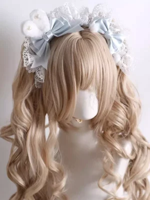 Sweet Lolita white lace frilled headband with light blue satin bows and pearl embellishments displayed on blonde curly twin wigs mannequin, front view