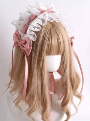 Sweet lolita white lace headdress with pink satin bows and ribbon tails worn on mannequin, left three-quarter view showing ruffled lace trim and decorative top bow detail
