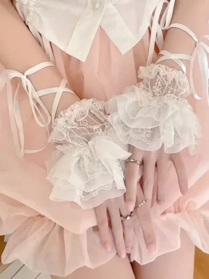 Sweet lolita white ruffled lace wrist cuffs oversleeves worn on model with pink skirt close-up overhead view detail