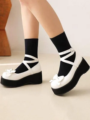 Sweet Lolita wedge heel pumps white upper black sole with decorative bow side profile view model wearing black ankle socks