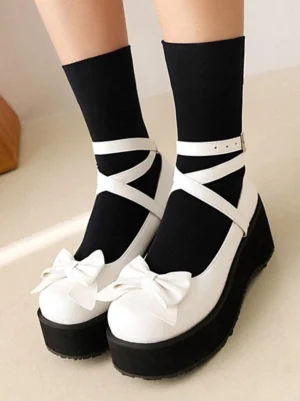 Sweet Lolita platform wedge pumps white PU leather with bow embellishment and cross ankle straps front top-down view model wearing black mid-calf socks