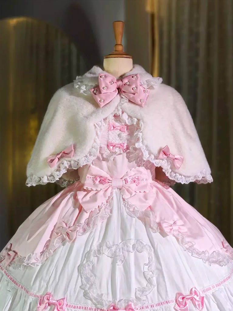 Sweet lolita white plush bunny ear cape with pink bow collar paired over pink lolita dress on mannequin, scalloped lace edge detail