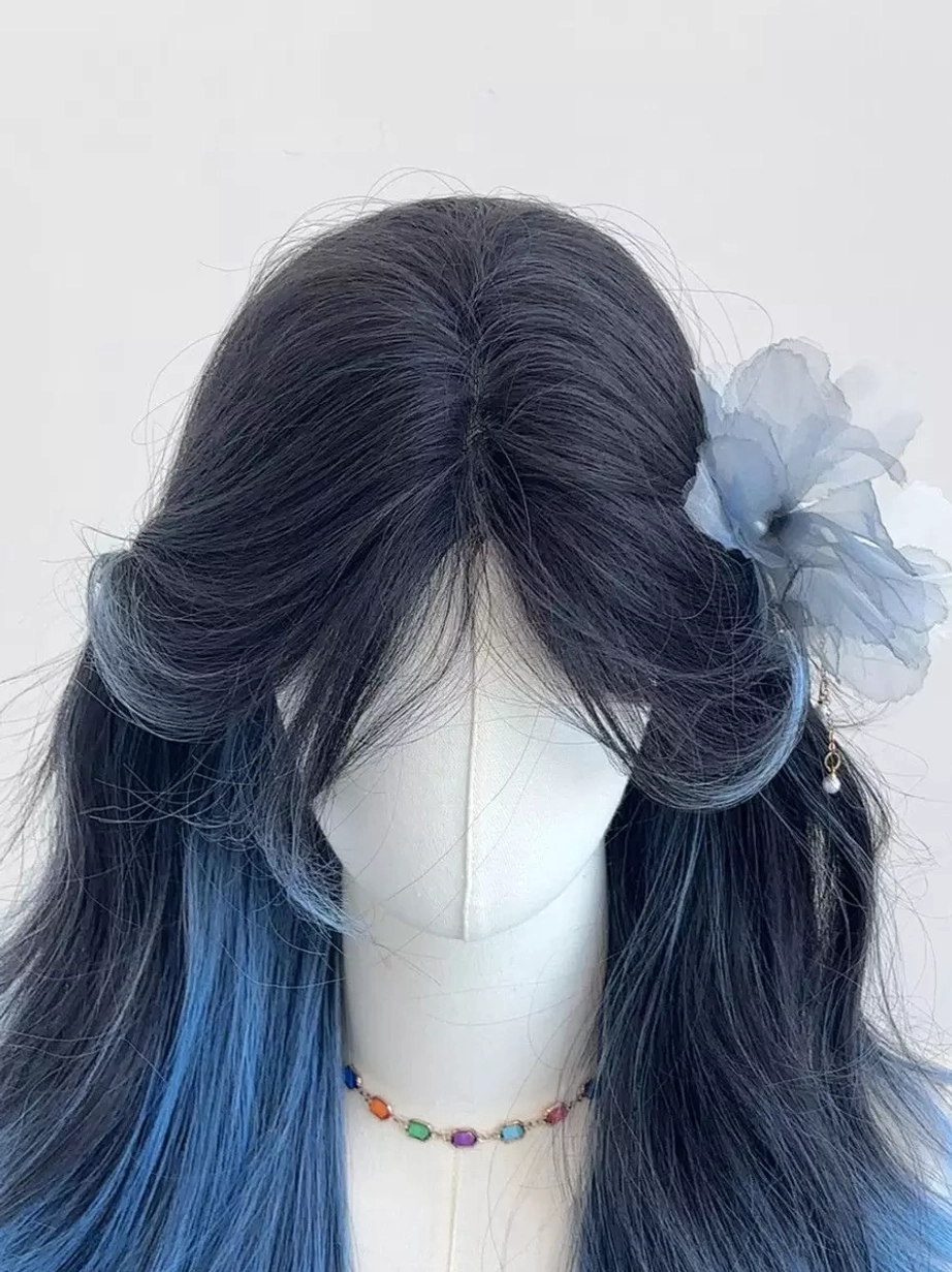 Front close-up of blue ombre long wavy Lolita wig with blue flower hairpin and beaded necklace