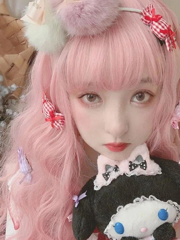 Front close-up of light pink sweet lolita wig with neat air bangs fuzzy hairband and black cute plush toy accessory