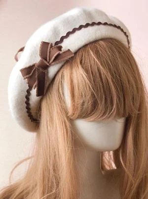 Sweet Lolita wool beret with brown ribbon bow and matching ric rac trim, three-quarter front view showcasing off-white felt base and decorative details