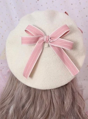 sweet-lolita-headdress-beret-rear-overhead-angle-showing-pink-ribbon-bow-with-white-button-details-and-off-white-wool-construction