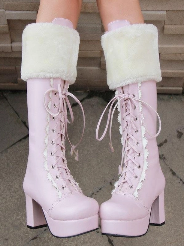 Pair of sweet pink lolita mid-calf boots on model's feet front static view showing white fuzzy collar, lace-up front, platform chunky heel, decorative lace trim on stone tile floor