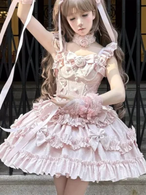 Pink sweet lolita jumper dress front three-quarter angle outdoor model with curly hair wearing matching wrist cuffs choker and layered frilly skirt