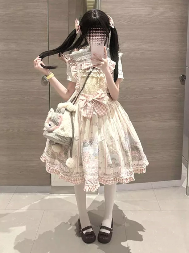 Sweet pink short-sleeve lolita dress with ruffled Peter Pan collar and front gingham bow worn in three-quarter mirror selfie showing full sweet lolita coordination