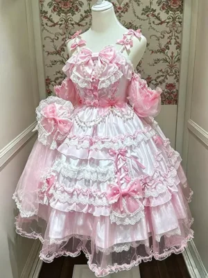 Pink sweet lolita dress front view with tiered lace ruffles and oversized pink bows, multi-layered tulle skirt, satin bodice with pearl accents