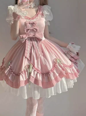 Sweet pink Lolita fairy dress with ruffled skirt and puff sleeves worn by young woman in mirror selfie, featuring bows and white tulle underskirt