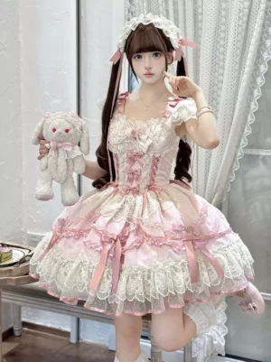 Sweet pink sleeveless lolita jumper dress with layered lace ruffled hem, satin bow accents, and corset bodice worn by model with twin tails hairstyle holding plush rabbit toy indoors