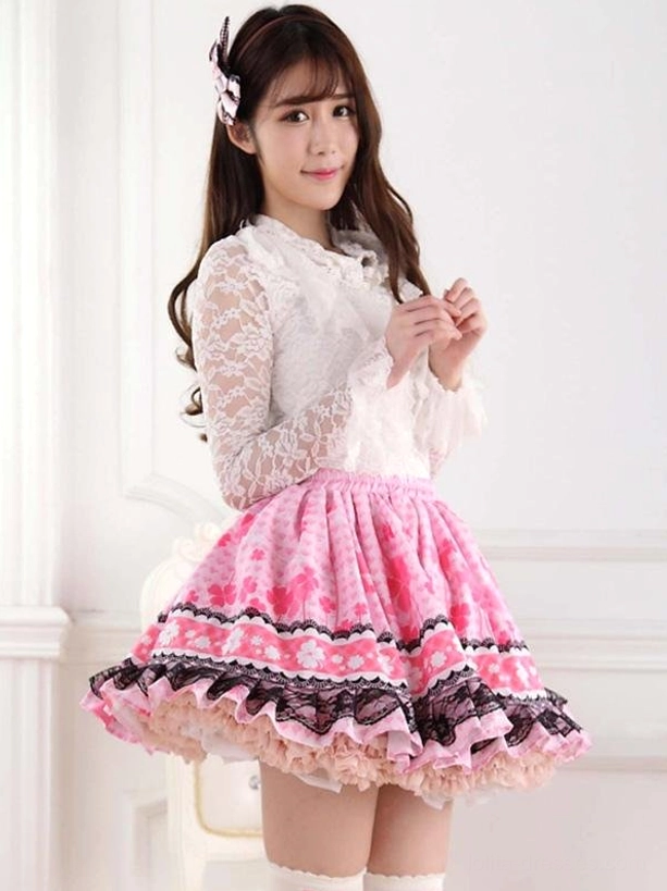 Three-quarter side view of pink lolita skirt featuring layered black lace trim, decorative hair accessory, and elegant skirt silhouette in studio lighting