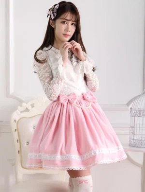 sweet pink lolita short skirt with white lace trim and fluffy pink bow waist detail front view vintage studio setting