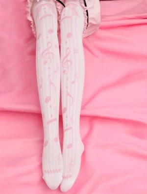 Pink music note lolita socks overhead view on legs with pink bedding background featuring light vertical stripes and frilled waist edge detail