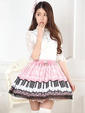 Sweet pink piano print lolita skirt front three-quarter view with black lace hem, featuring decorative bow and metal charms, worn with white thigh-high stockings in vintage room setting