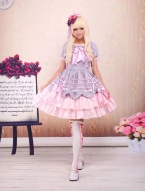 Sweet purple and pink tiered lolita OP dress full front view modeled by girl with short puff sleeves and decorative bows