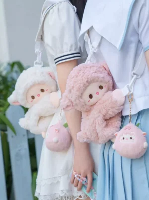Pink sweet sheep plush crossbody bag worn by model in school uniform lolita coordinate outdoor waist-level view