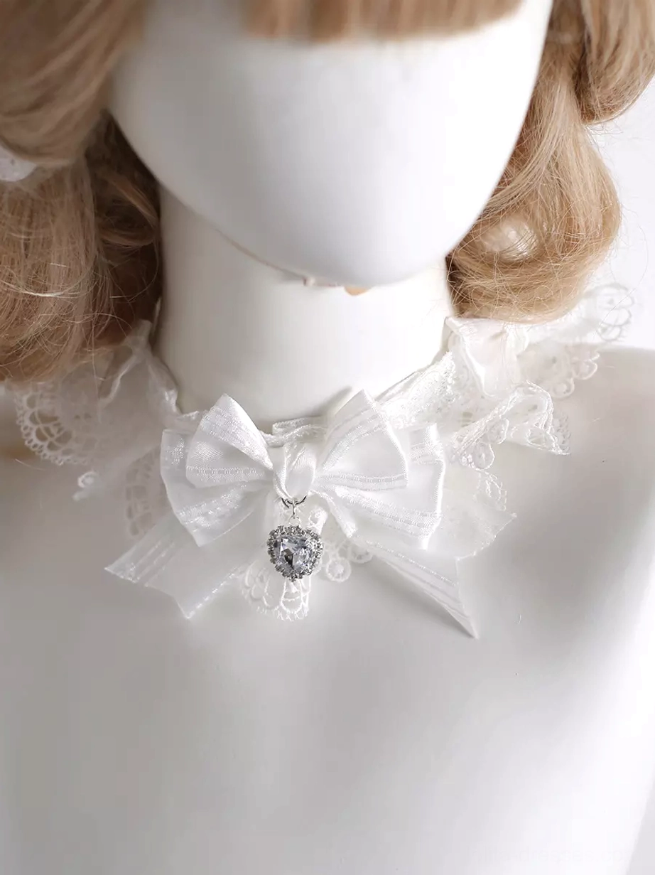 Sweet white lace choker with satin bow and heart crystal pendant worn on mannequin front close-up view lolita rococo neckwear