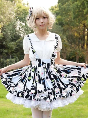 Sweet lolita suspender skirt set with teacup floral print, white ruffle blouse, front three-quarter view on model in outdoor garden setting