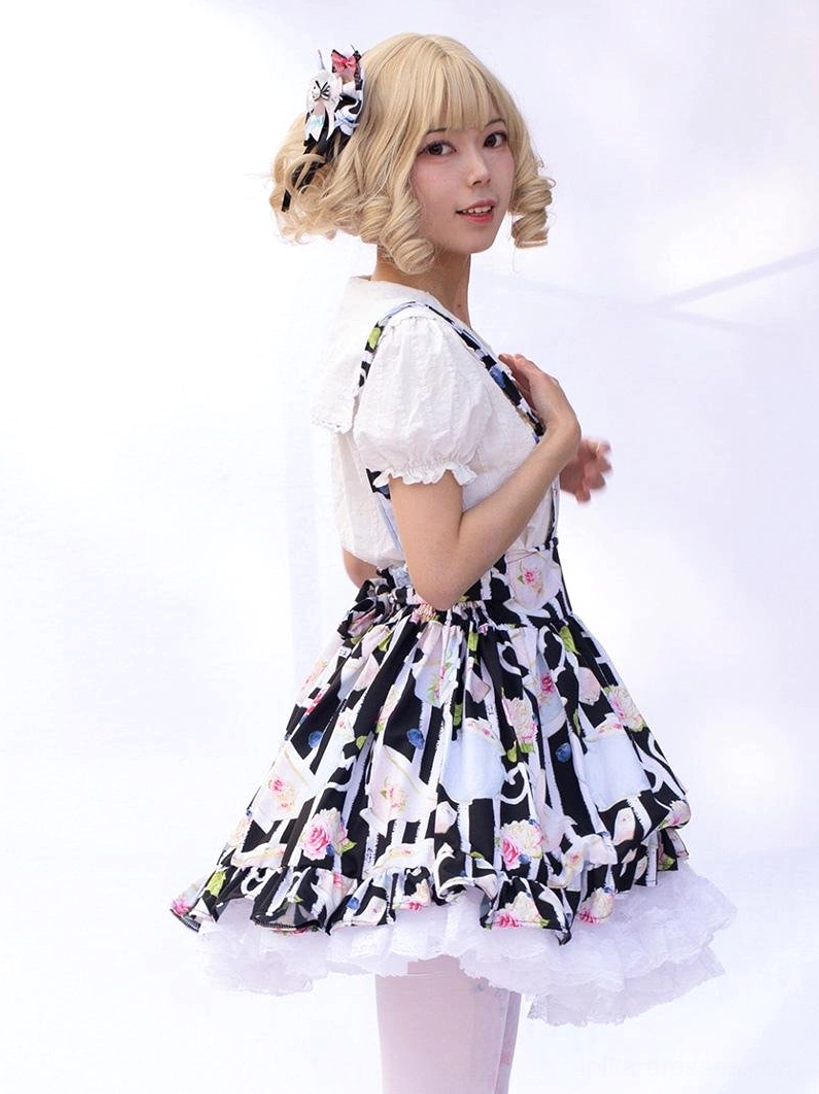 Sweet lolita suspender skirt with teacup rose floral print and white lace hemline, side three-quarter angle studio photography