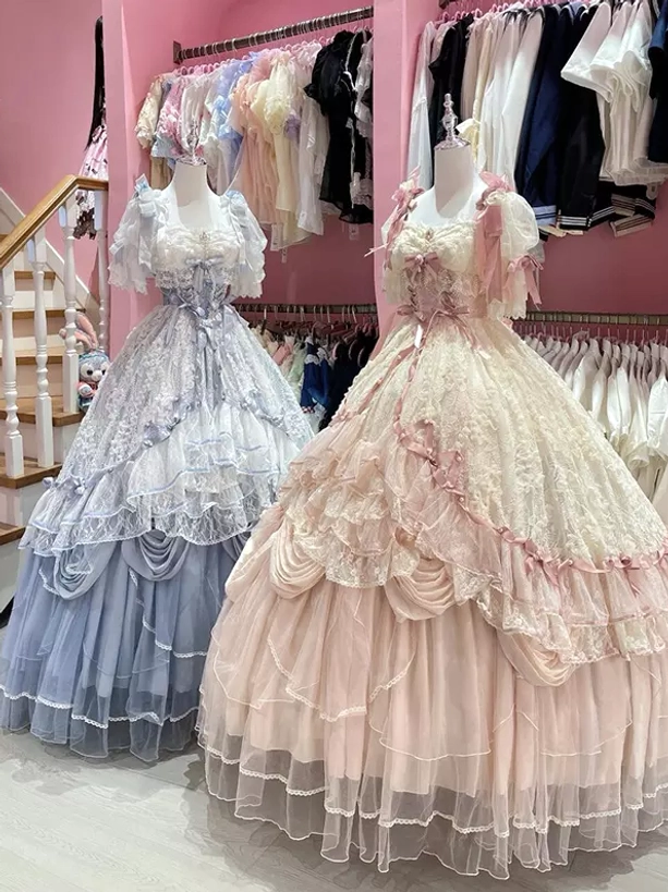 Two lolita formal dresses comparison left blue gray tiered gown right pink cream lace ruffled gown