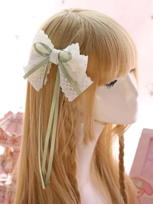 side profile of two-tone lace bow lolita hair clip with decorative long ribbon streamers, worn on blonde bangs braided hair model