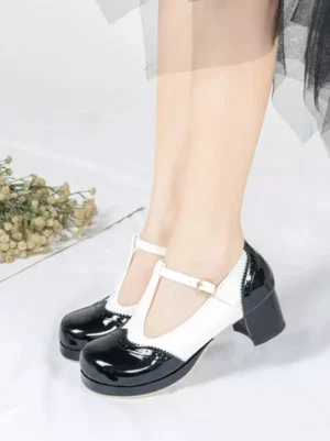 Front dual-leg view of two-tone T-strap Mary Jane pumps featuring patent leather finish, platform block heel, T-strap buckle closure, lolita style shoes on model with black tulle