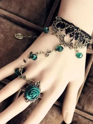 Vintage black lace lolita hand chain with emerald green rose ring and antique bronze vine metal accents on mannequin hand display
