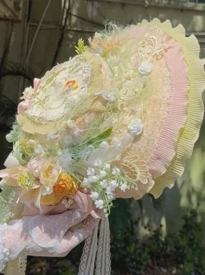 Vintage lolita bonnet hat with central medallion fluffy trims and pearl accents right side profile